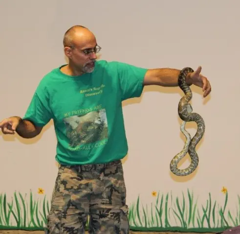 Wildlife educator presenting a snake to a scout troop