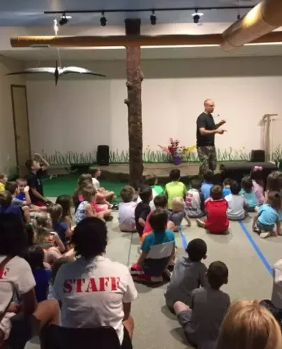 Educator working with a seated group in a quiet indoor space