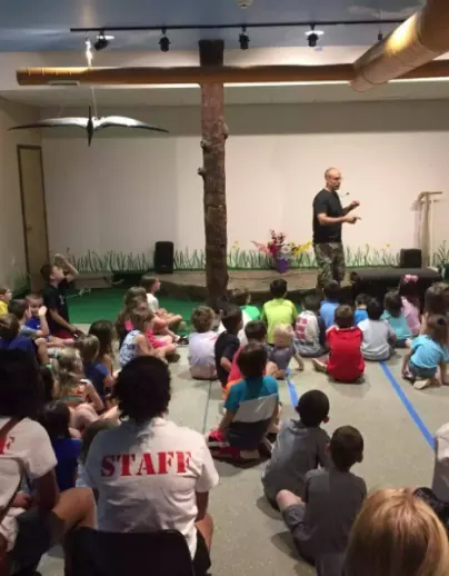 Educator working with a seated group in a quiet indoor space